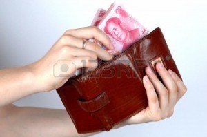 3455511-hand-holding-chinese-money-rmb-banknotes-putting-money-into-wallet